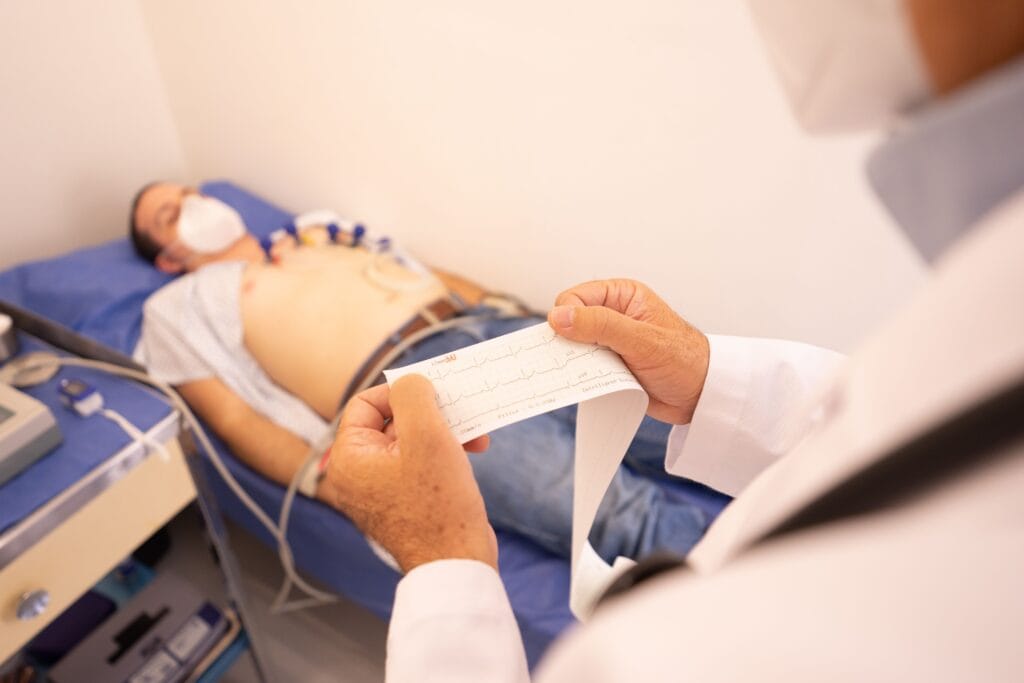 Clinician reviewing an ECG during assessment of an adult with chest pain.