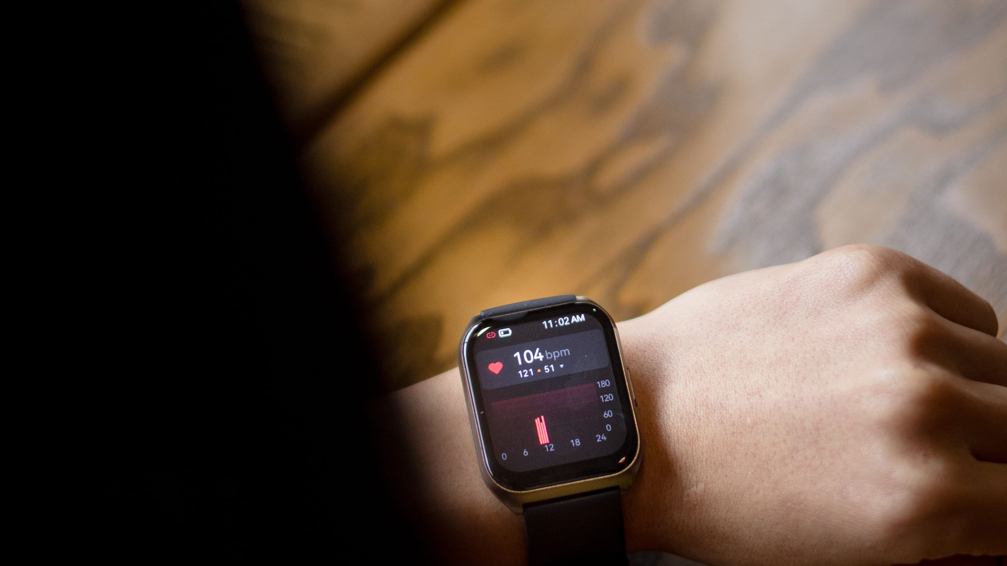 A smartwatch on a person's wrist displaying a heart-rate reading during palpitations.